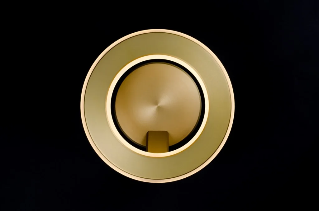 Electron wall sconce with circular illuminated ring, concealed fasteners, and inner and outer LED lighting. Designed and manufactured by Karice.