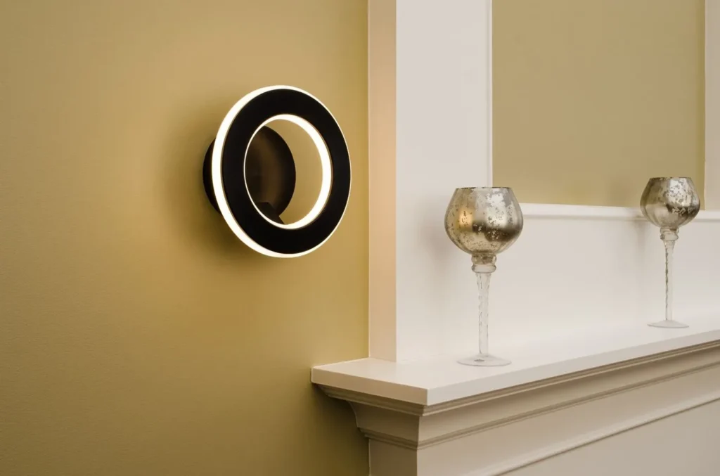 Electron wall sconce with circular illuminated ring, concealed fasteners, and inner and outer LED lighting. Designed and manufactured by Karice.