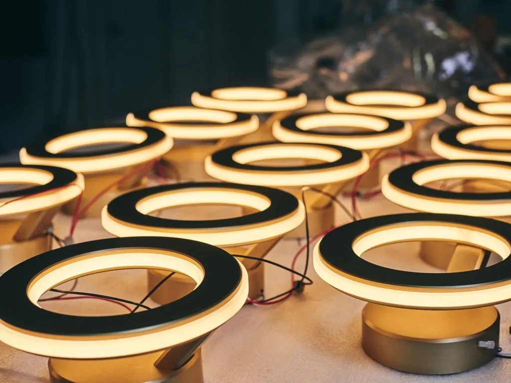 Electron wall sconce with circular illuminated ring, concealed fasteners, and inner and outer LED lighting. Designed and manufactured by Karice.