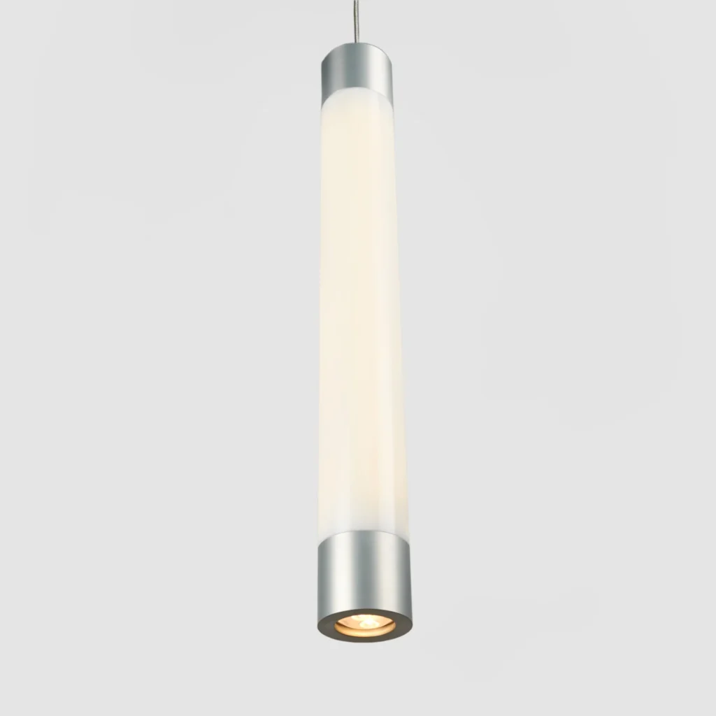 FUSE LED pendant light inspired by an automotive fuse, featuring a vertical illuminated form, acrylic cylindrical shade, and slim suspended cable for a floating appearance. Manufactured by Karice.