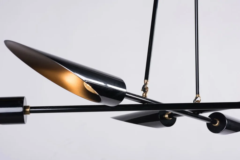 Harmony mid-century chandelier with six lamps, brass accents, and a gloss black finish. Manufactured by Karice.