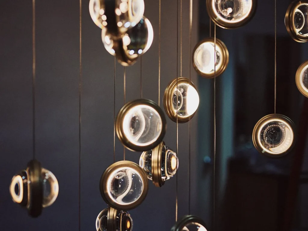 Infinity modern pendant with rotating glass orbs. Designed and manufactured by Karice.