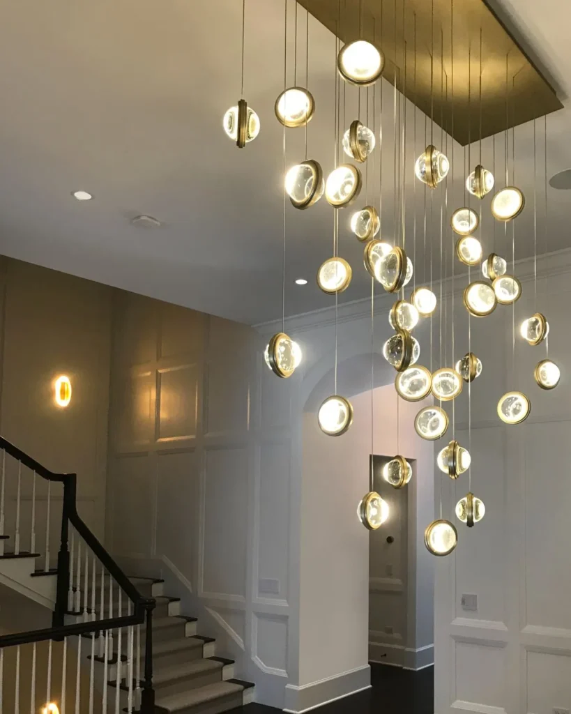 Infinity modern pendant with rotating glass orbs. Designed and manufactured by Karice.