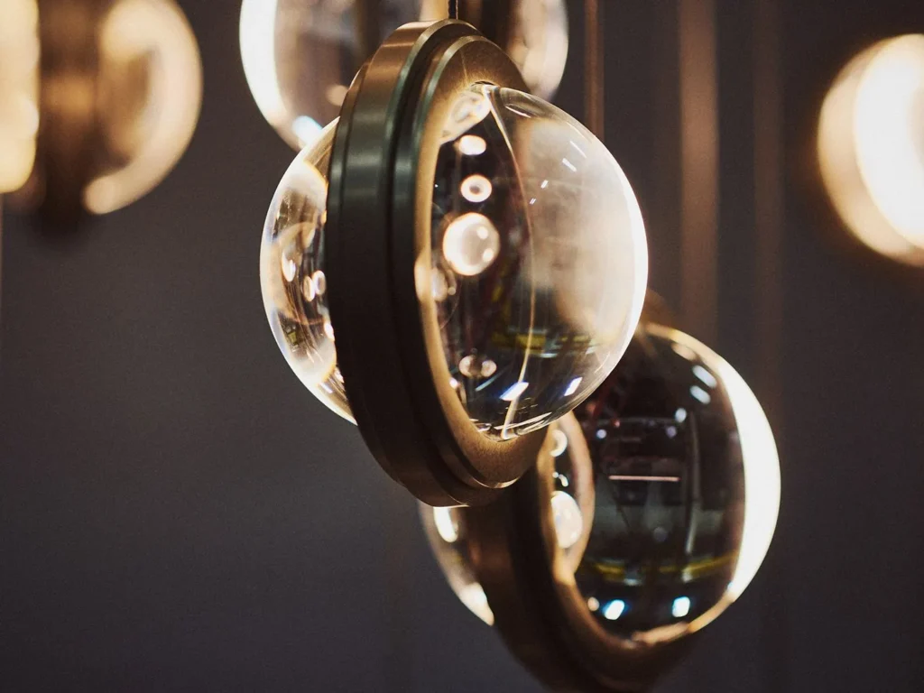 Infinity modern pendant with rotating glass orbs. Designed and manufactured by Karice.