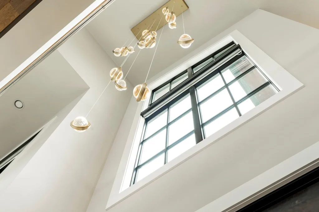 Infinity modern pendant with rotating glass orbs. Designed and manufactured by Karice.