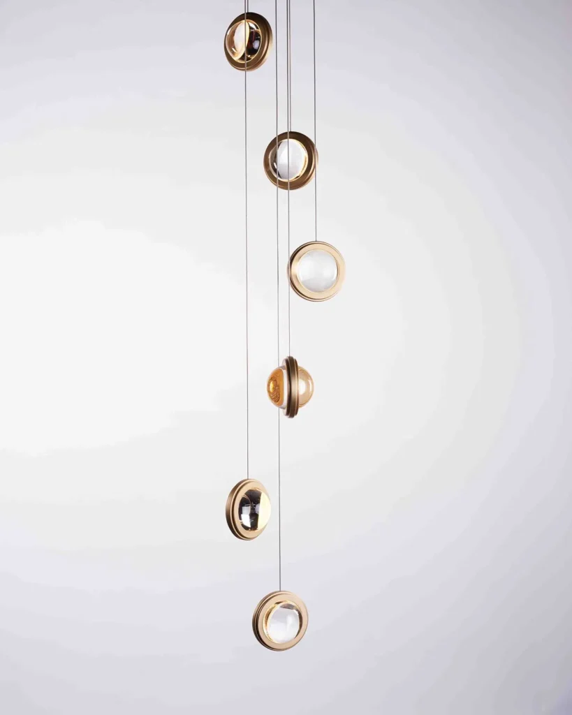Infinity modern pendant with rotating glass orbs. Designed and manufactured by Karice.