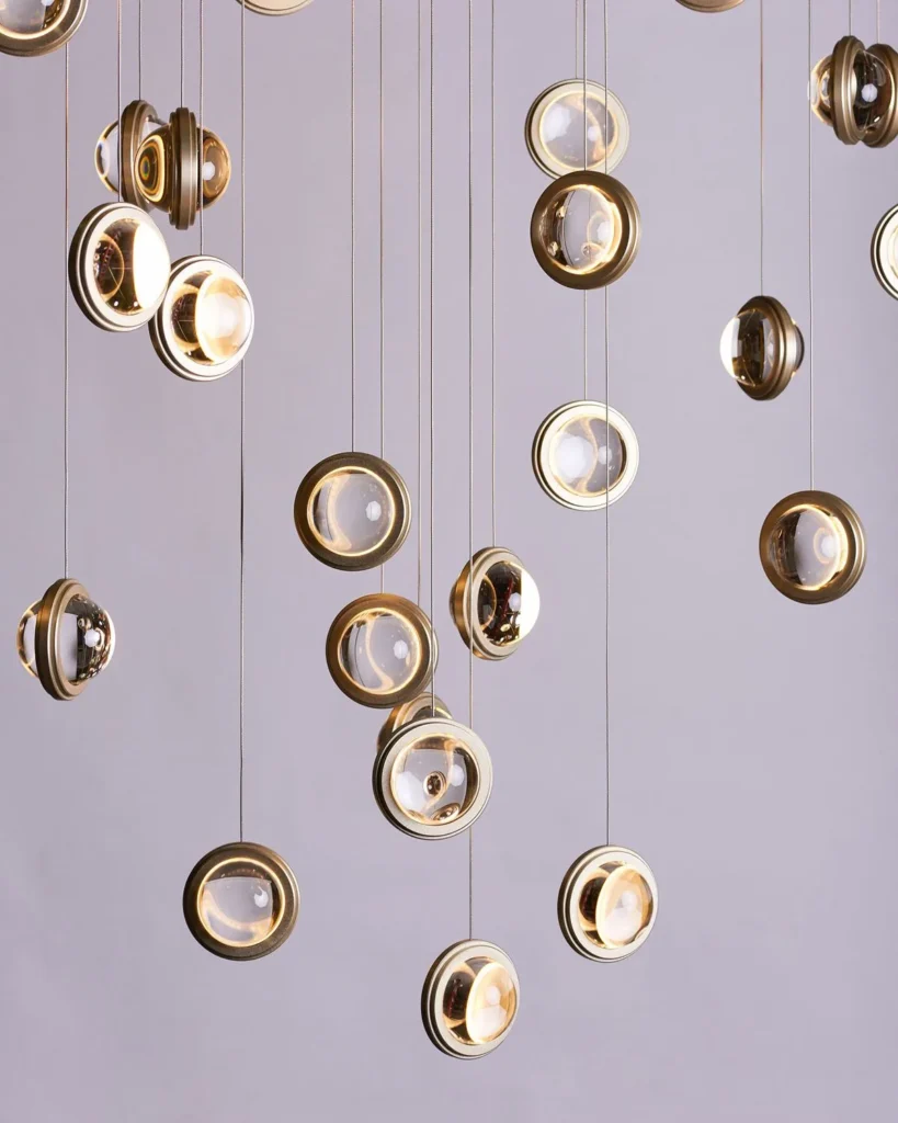 Infinity modern pendant with rotating glass orbs. Designed and manufactured by Karice.