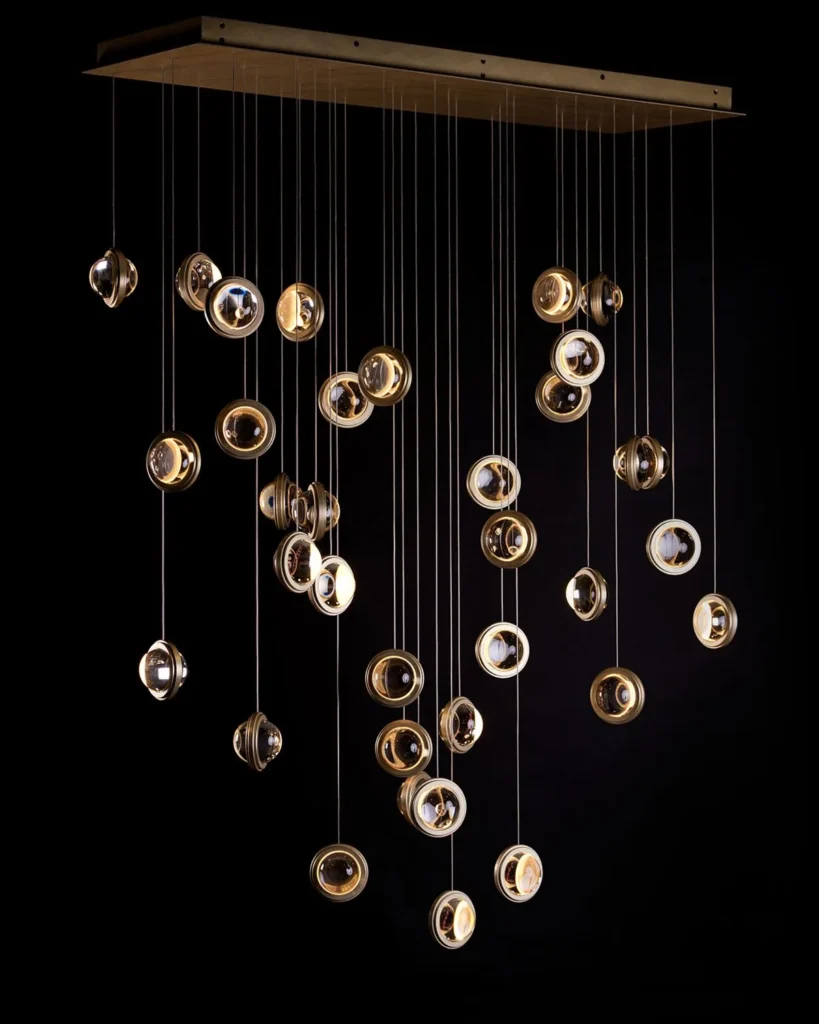 Infinity modern pendant with rotating glass orbs. Designed and manufactured by Karice.