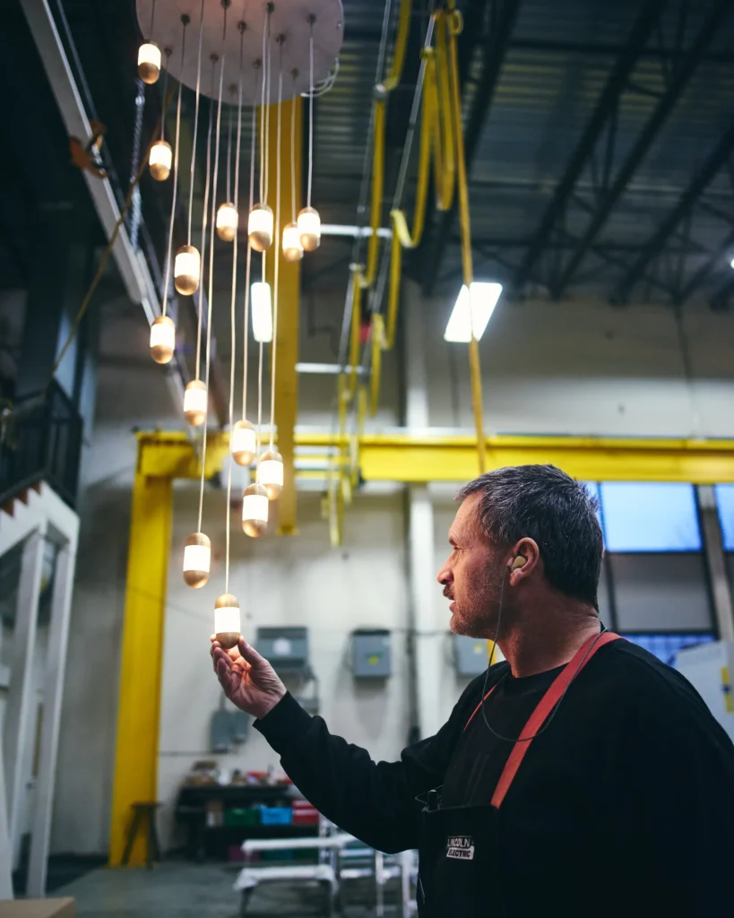 Karice team fabricating the OLO LED pendant light with oval acrylic diffuser.