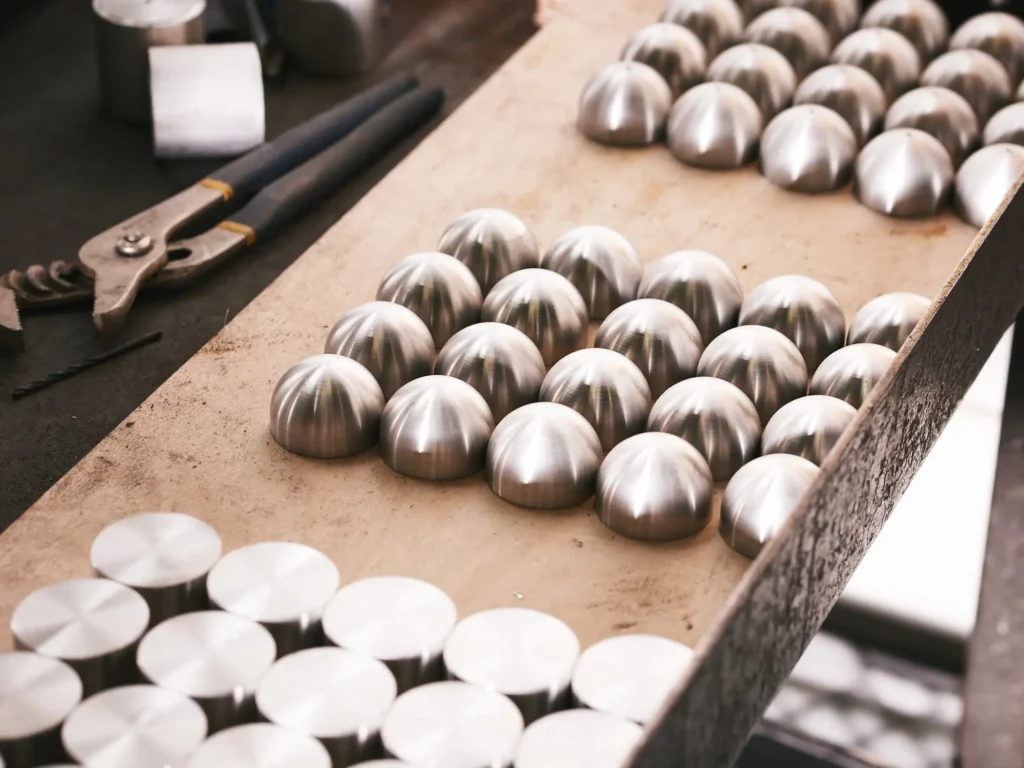 Karice team fabricating the OLO LED pendant light with oval acrylic diffuser.