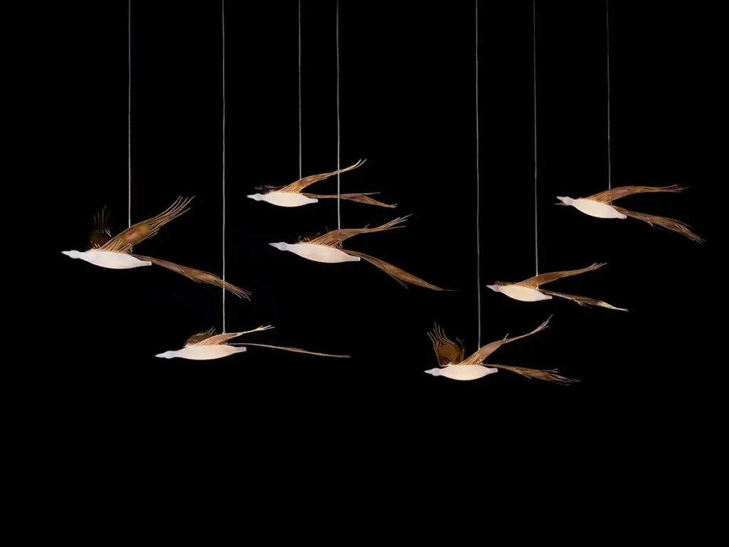 Phoenix pendant lighting by Karice. Inspired by the mythological Phoenix bird, handcrafted using genuine brass, and suspended from a simple coaxial cable.