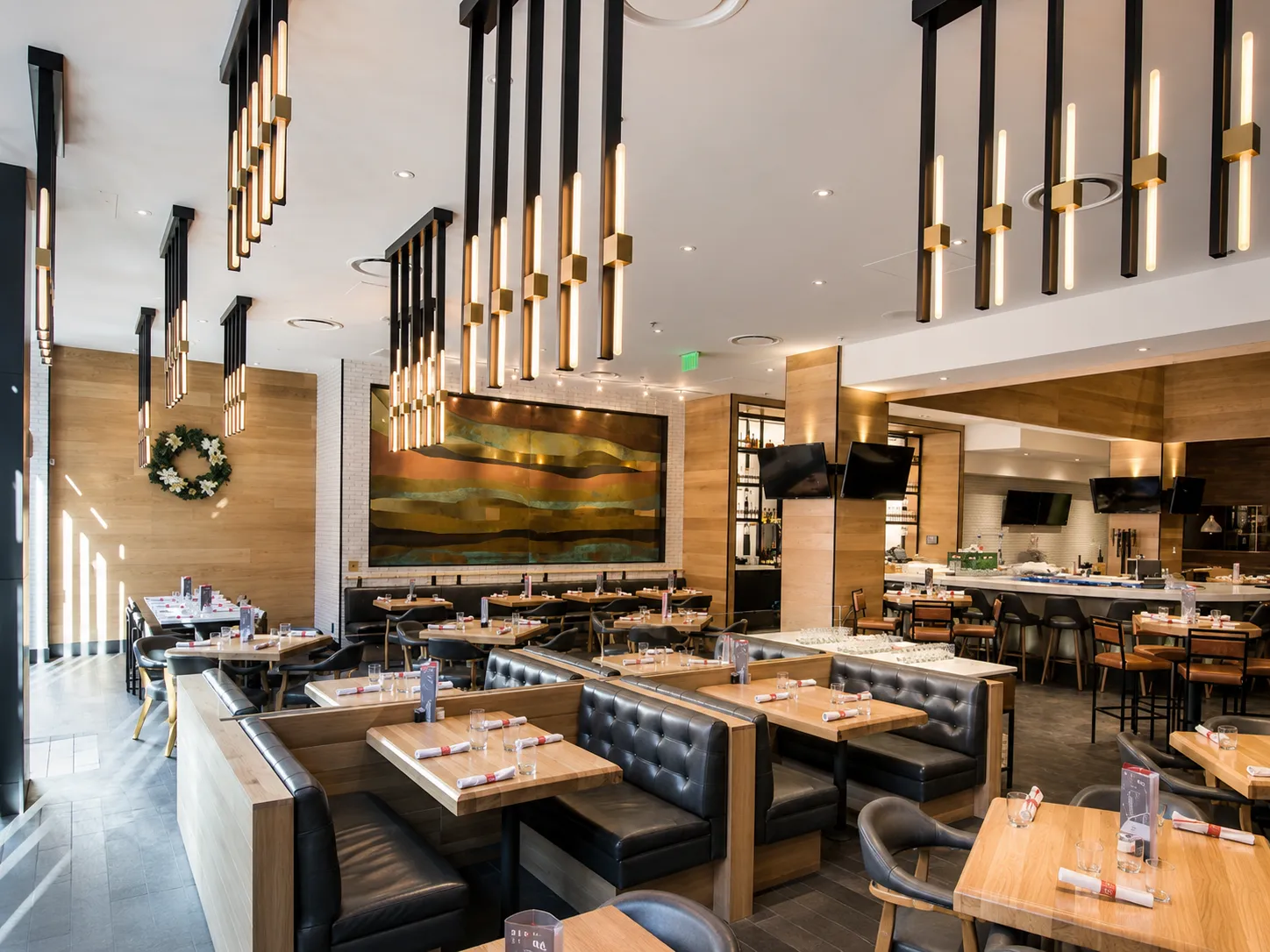 Custom inverted vertical tube pendant lighting for Earls Kitchen & Bar in Glenarm, Denver, CO, USA. Manufactured and designed by Karice.