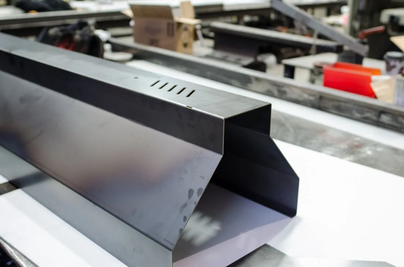 Custom trough light pendant for Lush Cosmetics. Manufactured by Karice.
