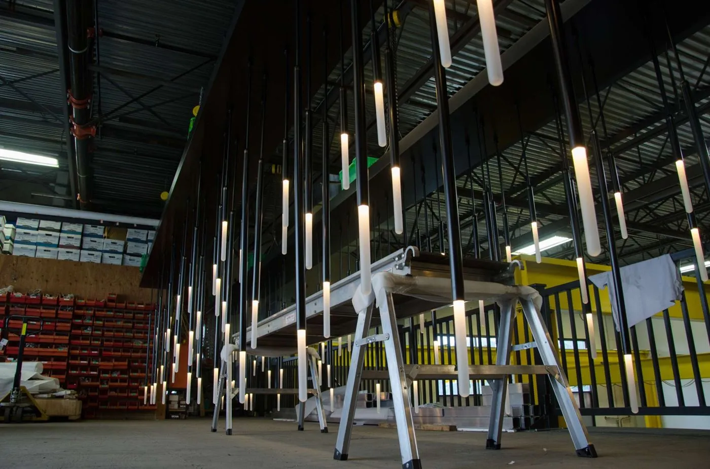 Custom tubular pendant lighting for Earls Kitchen and Bar in Tysons One Palace, McLean, VA, USA. Manufactured by Karice.