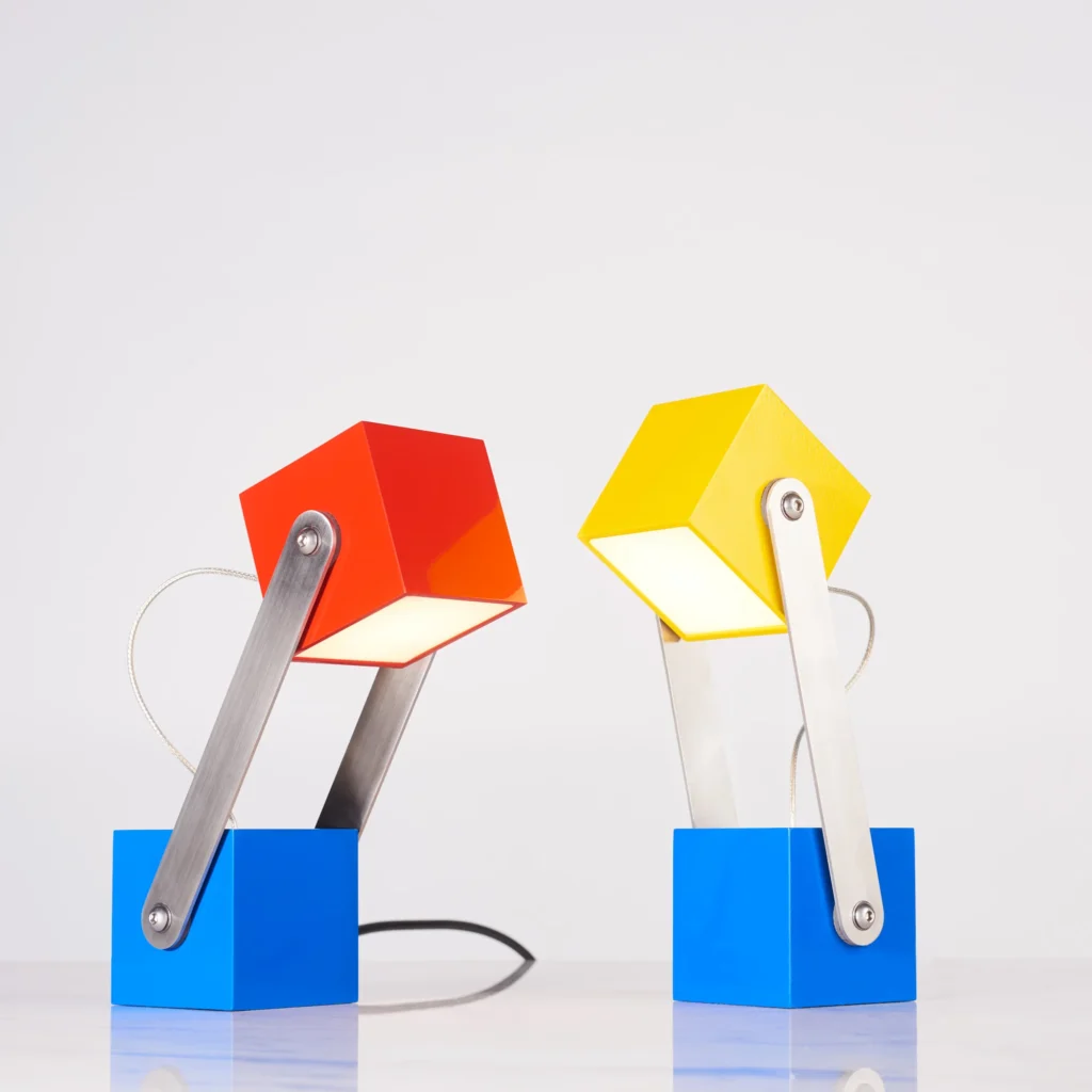 CUBE table lamp inspired by the Rubik’s Cube and Meccano sets, with an adjustable geometric design and multiple finish options. Designed and manufactured by Karice.