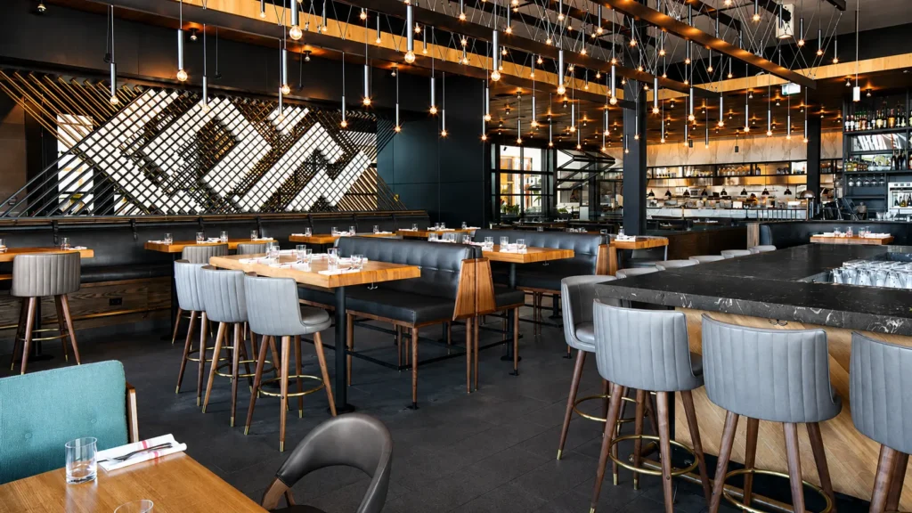 Large exposed bulb chandelier for Earls Kitchen and Bar in Dadeland, Miami, FL, USA. Manufactured by Karice.