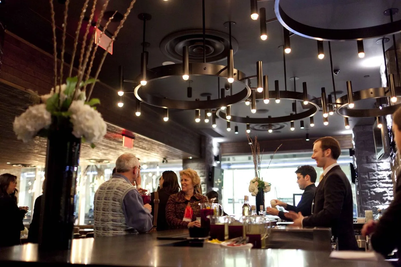 Large ring pendant chandeliers for Earls Kitchen and Bar in King Street, Toronto, ON, CA. Manufactured by Karice.