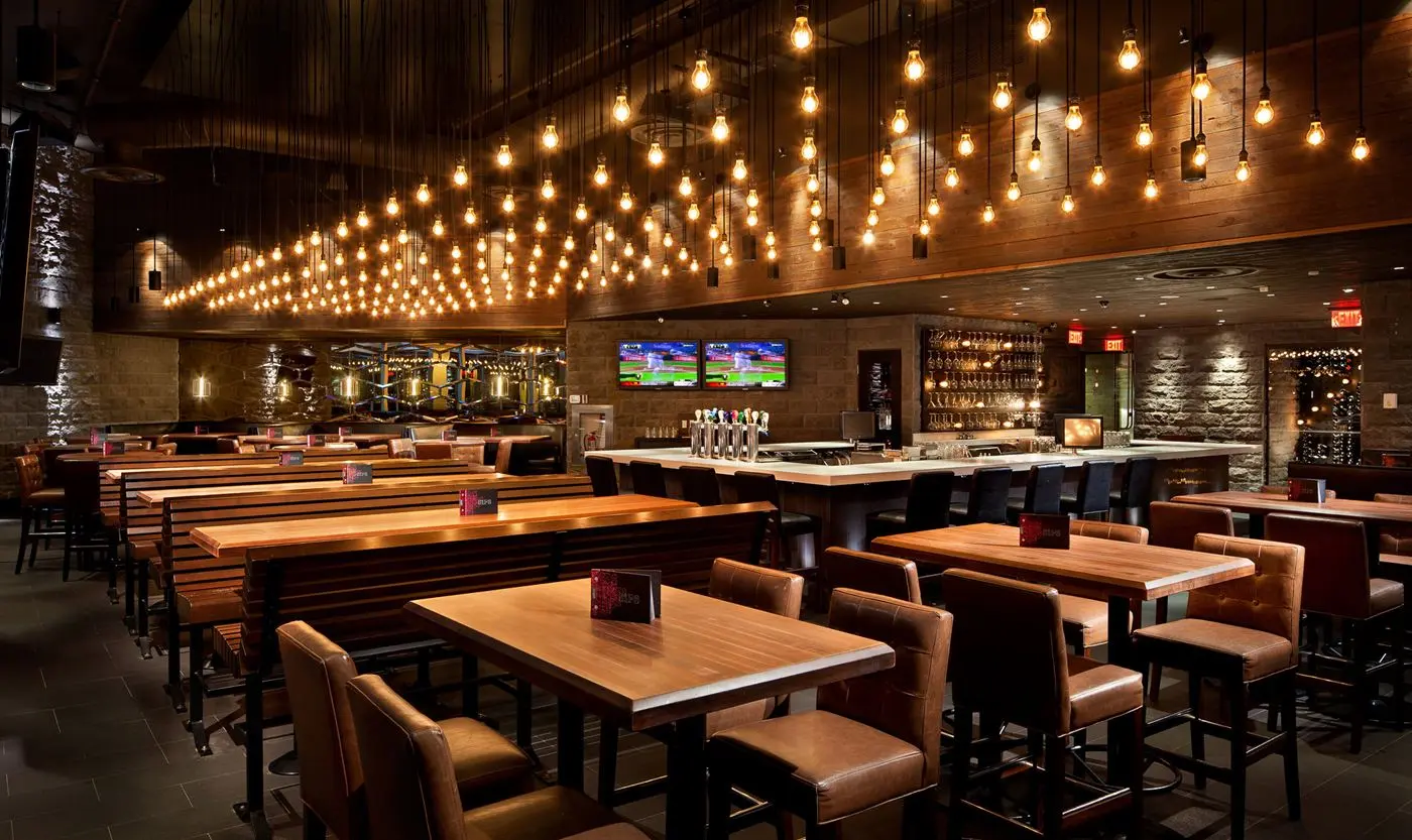 Multi-bulb pendant chandelier for Earls Kitchen and Bar in King Street, Toronto, ON, CA. Manufactured by Karice.