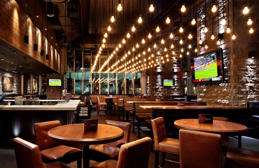 Multi-bulb pendant chandelier for Earls Kitchen and Bar in King Street, Toronto, ON, CA. Manufactured by Karice.