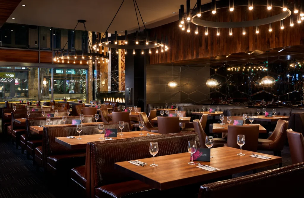 Custom wagon wheel chandeliers for Earls Kitchen & Bar in Lincoln Square, Bellevue, WA, USA. Manufactured by Karice.