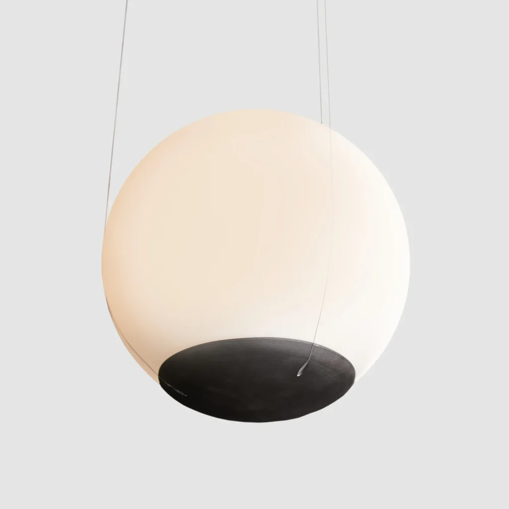 Eclipse pendant light with a perfect spherical form, suspended to appear weightless and floating, with dim-to-warm LED illumination. Designed and manufactured by Karice.