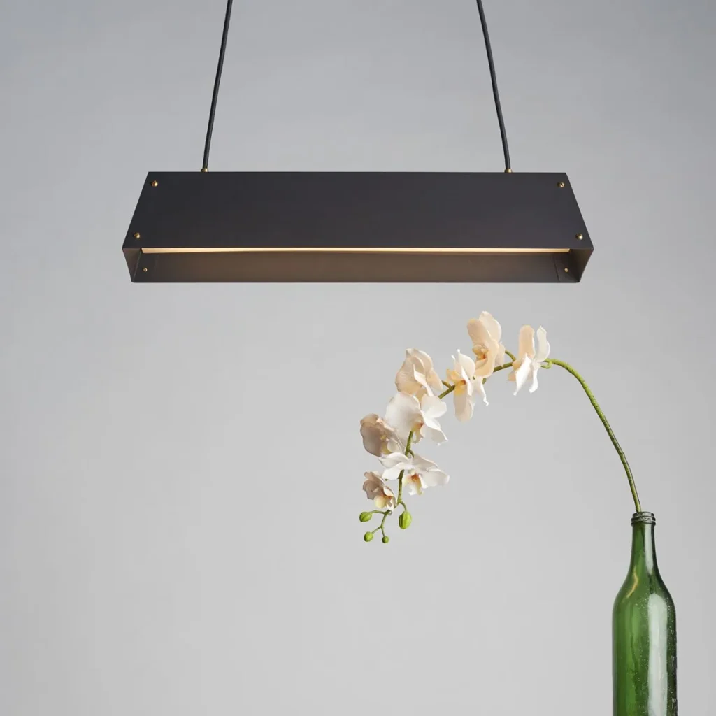 Expanse LED linear light with modular design, acrylic diffuser, braided cord suspension, and integrated LED driver. Designed and manufactured by Karice.