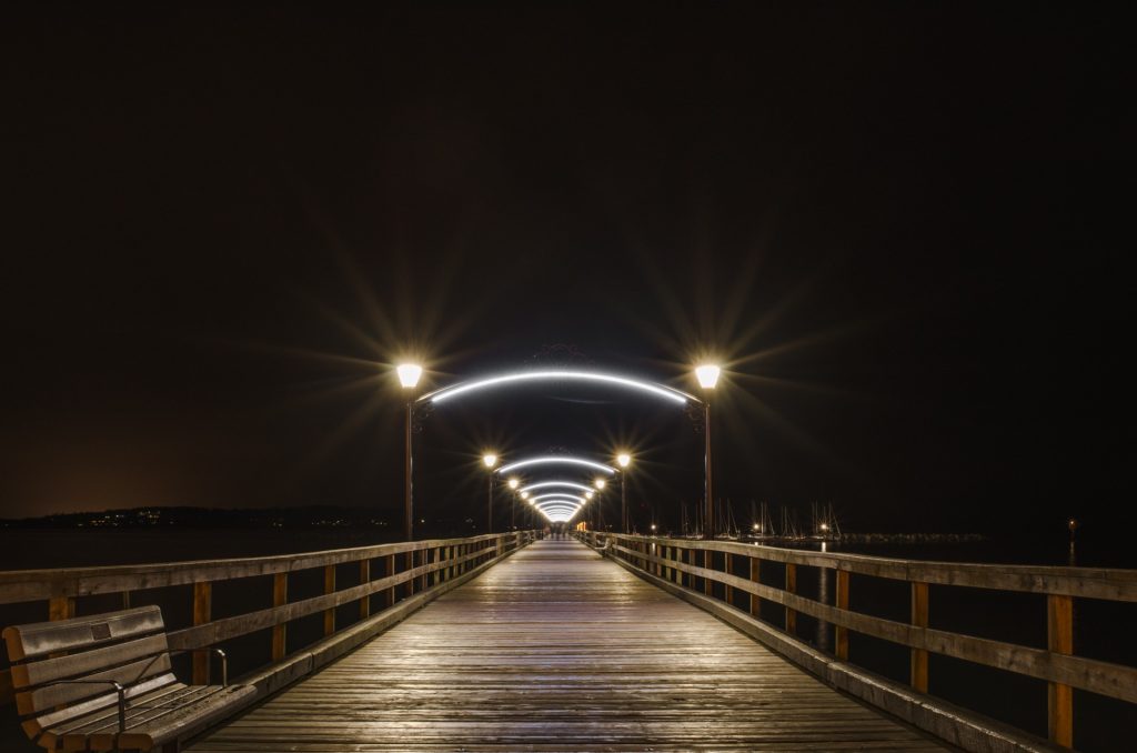 Arched waterfront pier lighting for White Rock Pier in White Rock, BC, CA. Karice manufactured.