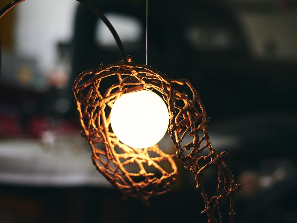 Decorative sculptural chandelier with illuminated globes and wire-like metalwork for a private residence. Manufactured by Karice in partnership with Marie Khouri.
