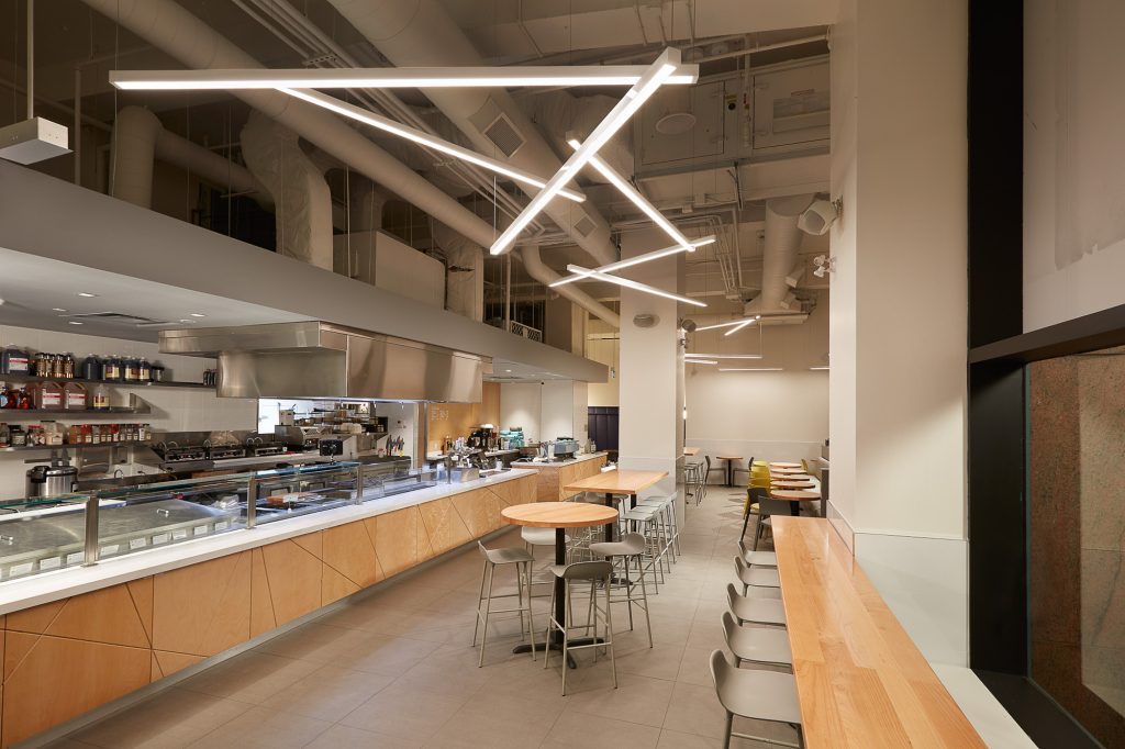 Architectural linear pendants for Tractor Foods Toronto. Manufactured by Karice.