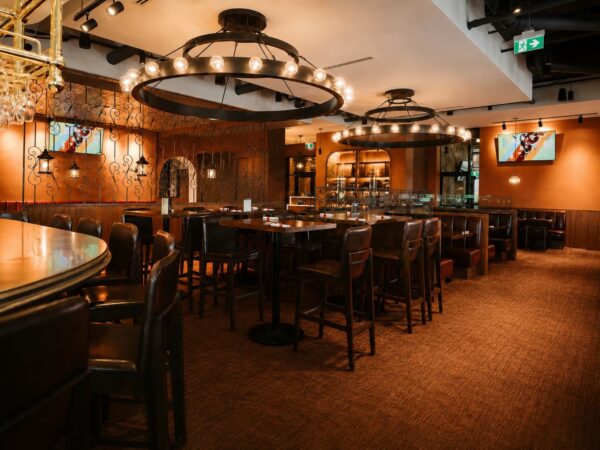 Large two-tiered ring chandeliers with exposed lamping for Brodeur's Bistro in Langley, BC, CA. Manufactured by Karice.