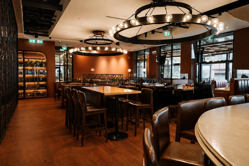 Two-tiered ring chandeliers with exposed lamping for Brodeur's Bistro in Langley, BC, CA. Manufactured by Karice.