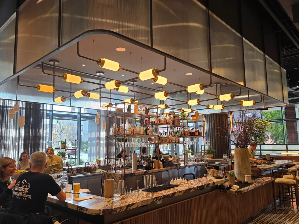 Custom linear cylinder bar pendant lighting for The Morris Proper in Morristown, NJ, USA. Fabricated by Karice.