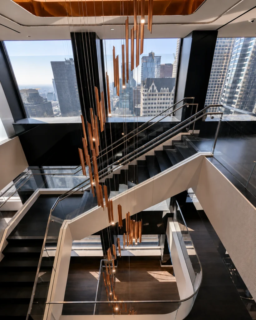 Custom multi-story stairwell chandelier for White and Case in Los Angeles, CA, USA. Manufactured by Karice.