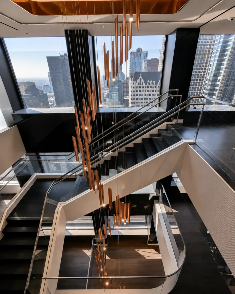 Custom multi-story stairwell chandelier for White and Case. Manufactured and installed by Karice.