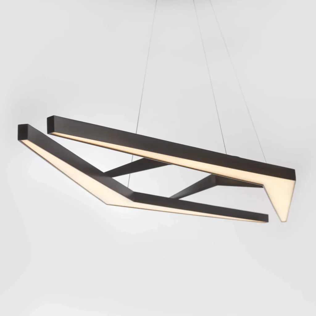 AREA 49 geometric luminaire with double-chevron form, aluminum construction, and powder-coated finish. Designed and manufactured by Karice.