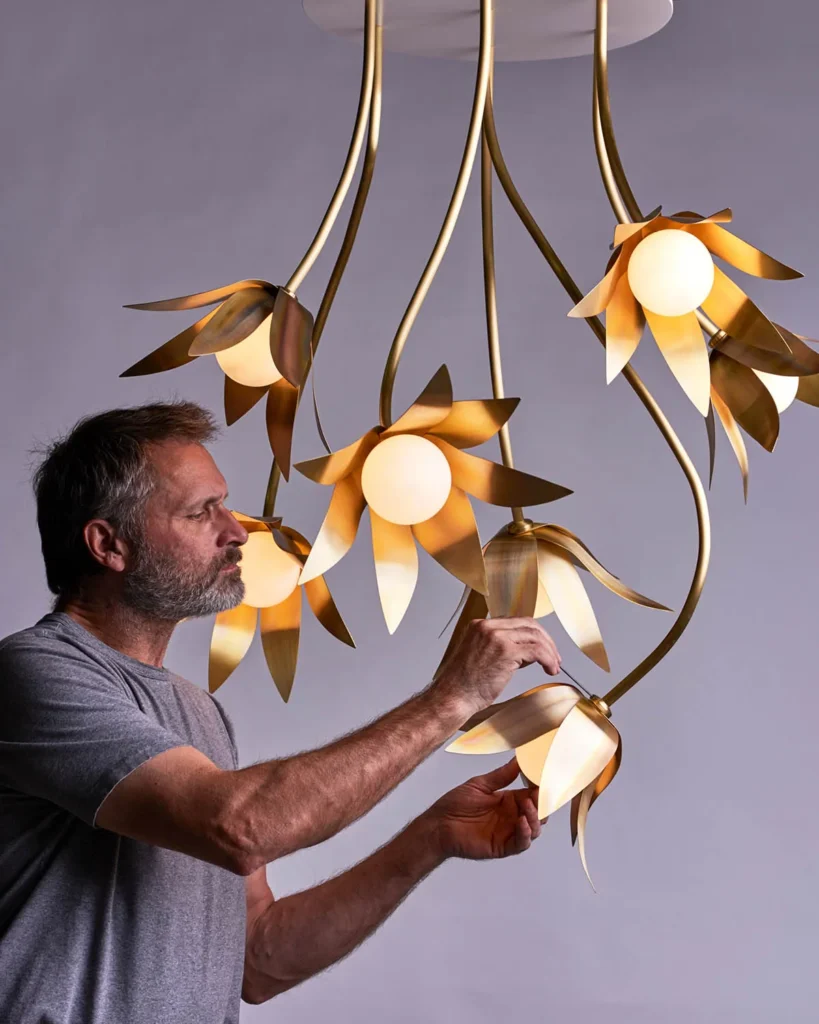 Bloom LED pendant with hand-blown glass and hand-formed brass petals, designed as a floral-inspired light fixture with dim-to-warm LED illumination. Designed and manufactured by Karice.