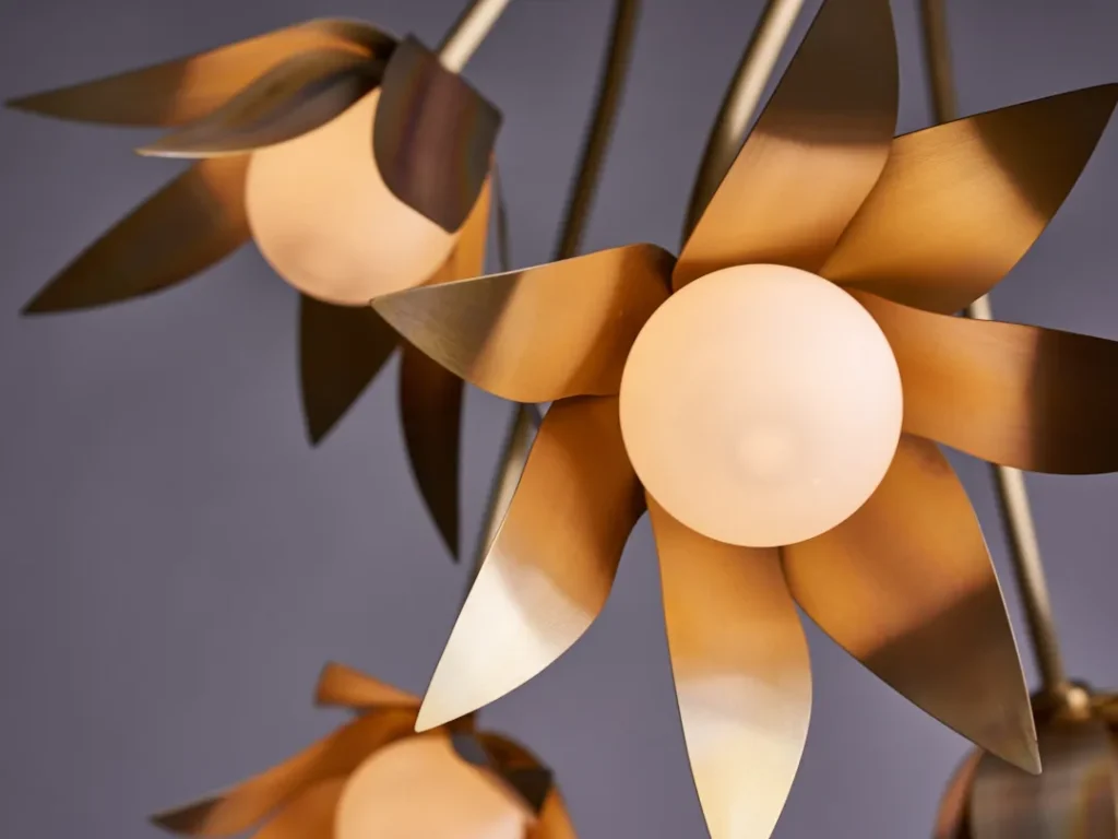 Bloom LED pendant with hand-blown glass and hand-formed brass petals, designed as a floral-inspired light fixture with dim-to-warm LED illumination. Designed and manufactured by Karice.