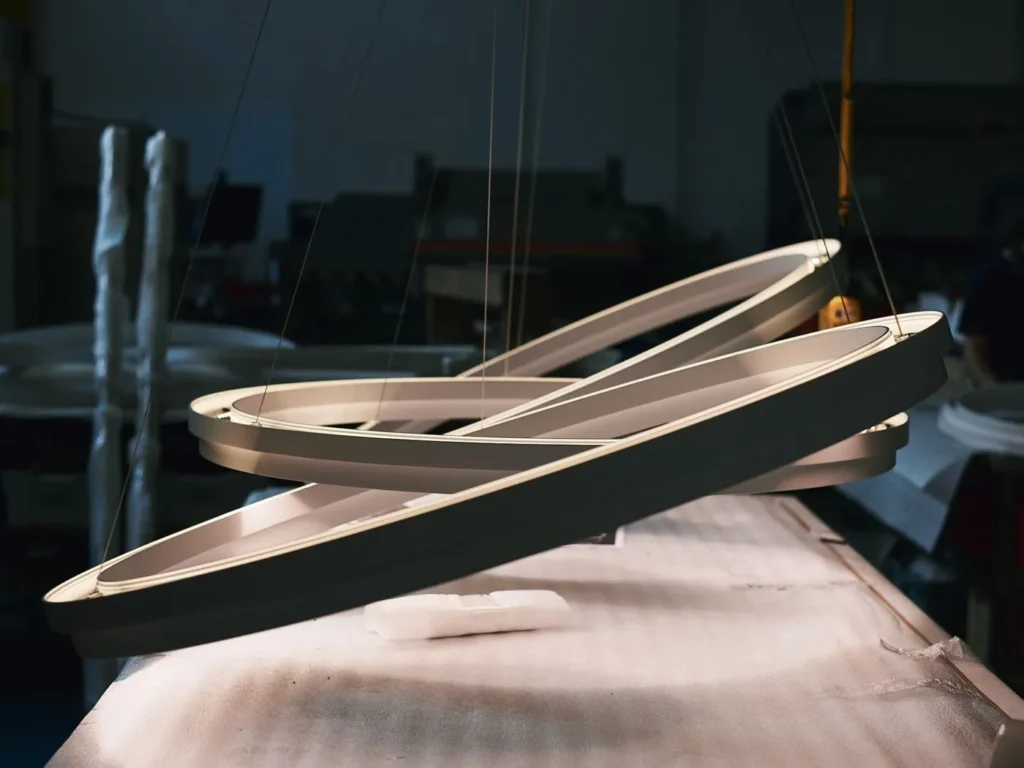 Circulus LED pendant light with circular aluminum form, 360-degree illumination, and stepped ring design in a medium bronze finish. Designed and manufactured by Karice.