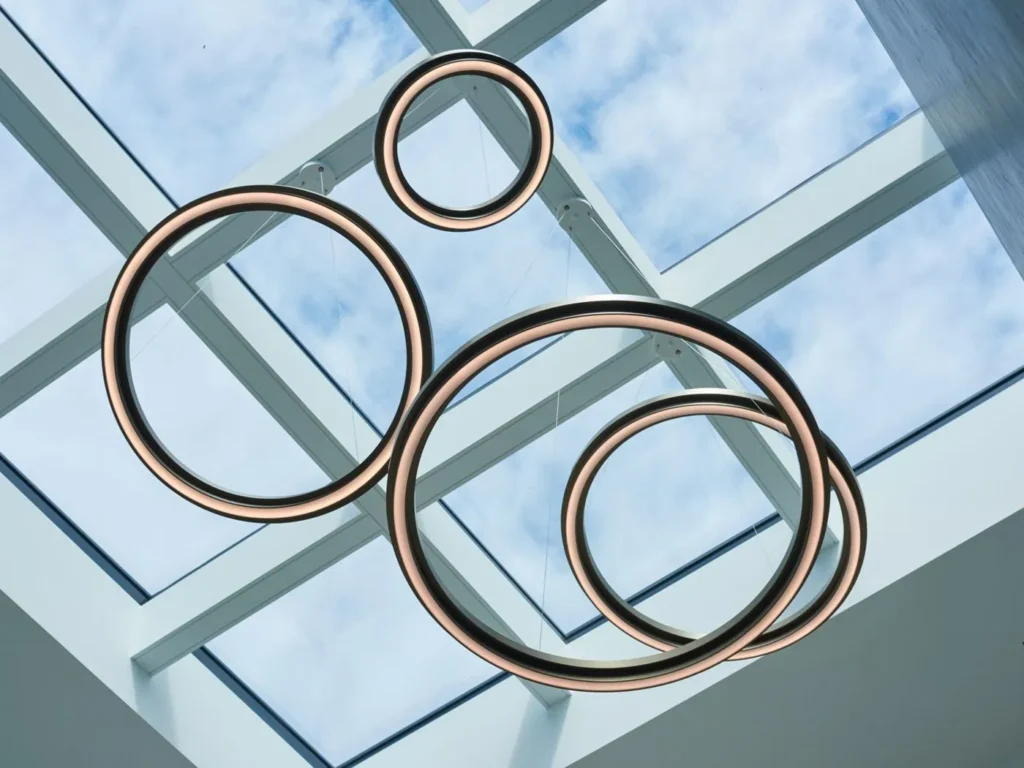 Circulus LED pendant light with circular aluminum form, 360-degree illumination, and stepped ring design in a medium bronze finish. Designed and manufactured by Karice.