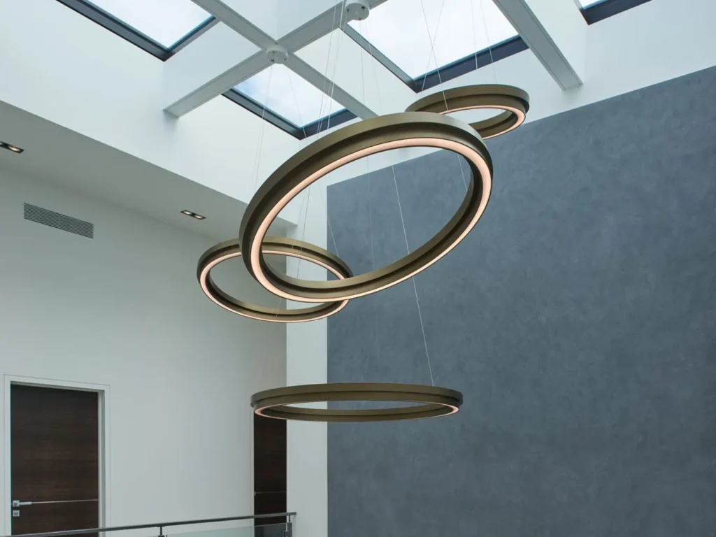 Circulus LED pendant light with circular aluminum form, 360-degree illumination, and stepped ring design in a medium bronze finish. Designed and manufactured by Karice.