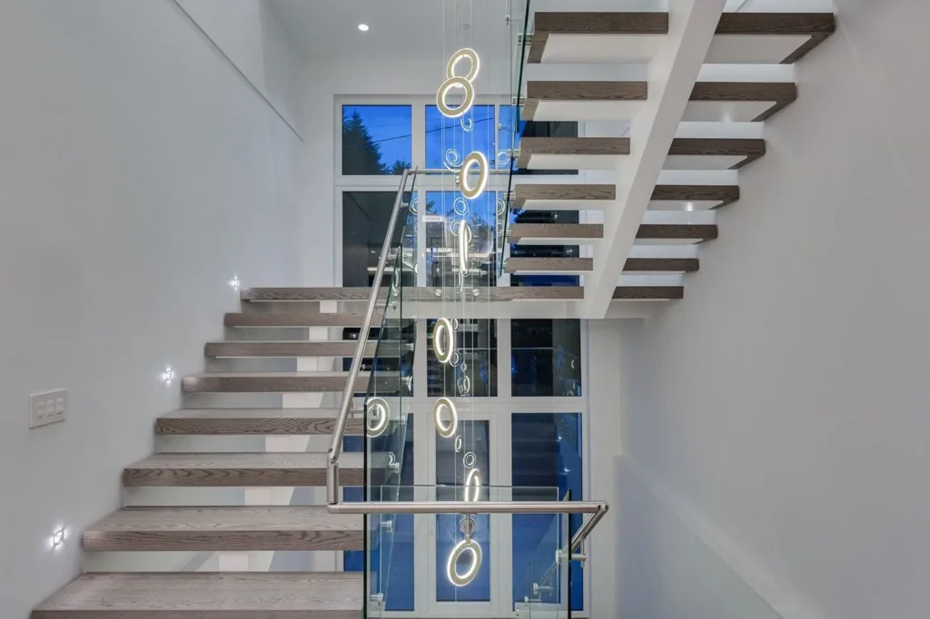 Electron LED pendant with illuminated inner and outer rings, frosted acrylic diffusers, and suspended floating design. Designed and manufactured by Karice.