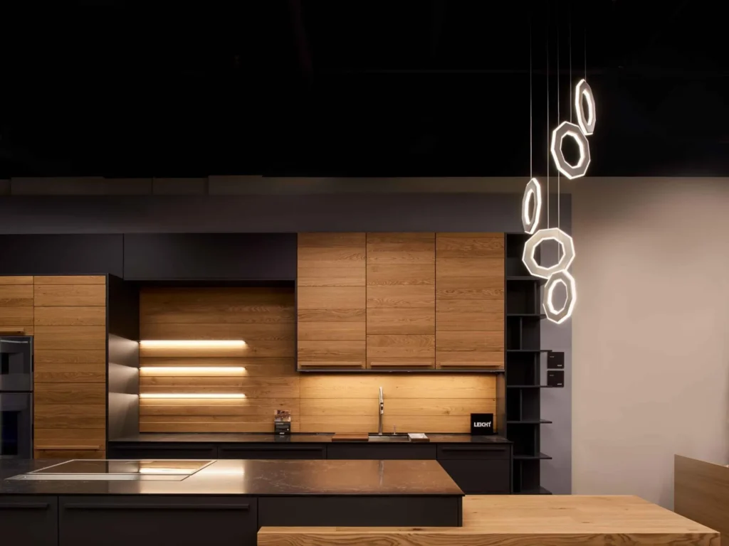 Ennea LED pendant with illuminated inner and outer geometric rings, concealed wiring, and suspended aluminum frame. Designed and manufactured by Karice.