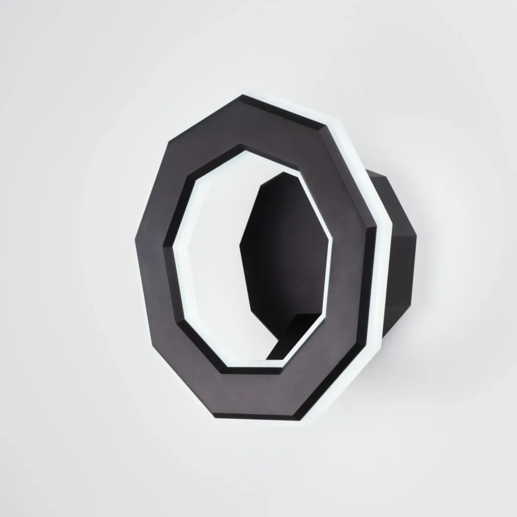 Ennea wall sconce with geometric rings, concealed fasteners, and dimmable inner and outer LED illumination. Designed and manufactured by Karice.