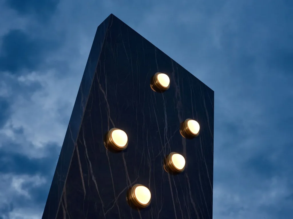 Infinity wall sconce with anodized aluminum, magnifying glass domes, concealed mounting plate, and adjustable illumination. Designed and manufactured by Karice.