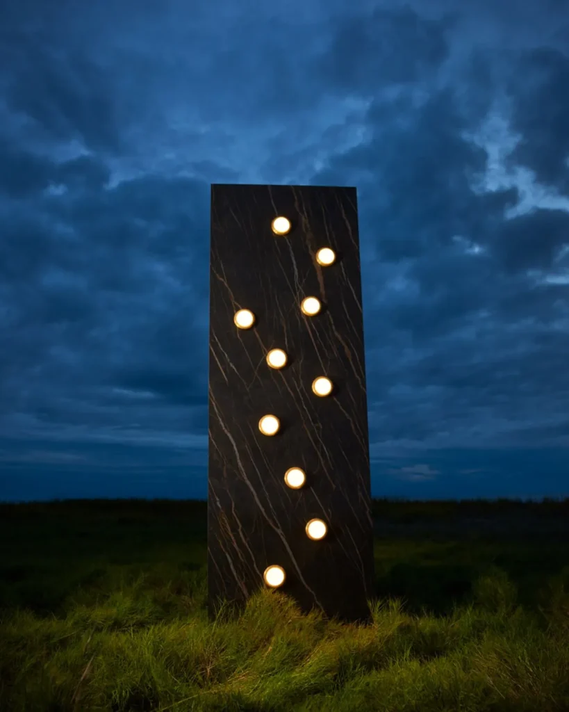 Infinity wall sconce with anodized aluminum, magnifying glass domes, concealed mounting plate, and adjustable illumination. Designed and manufactured by Karice.