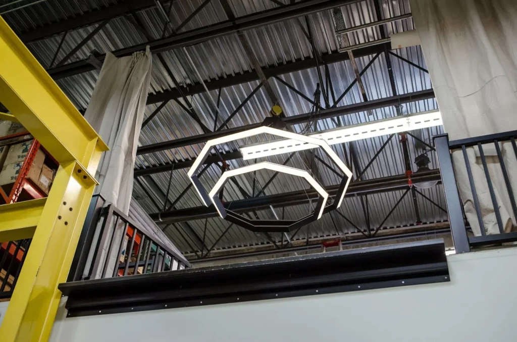 Luxennea Diamond sculptural chandelier with layered geometric tiers suspended by aircraft cables. Inspired by the Florentine Diamond. Designed and manufactured by Karice.