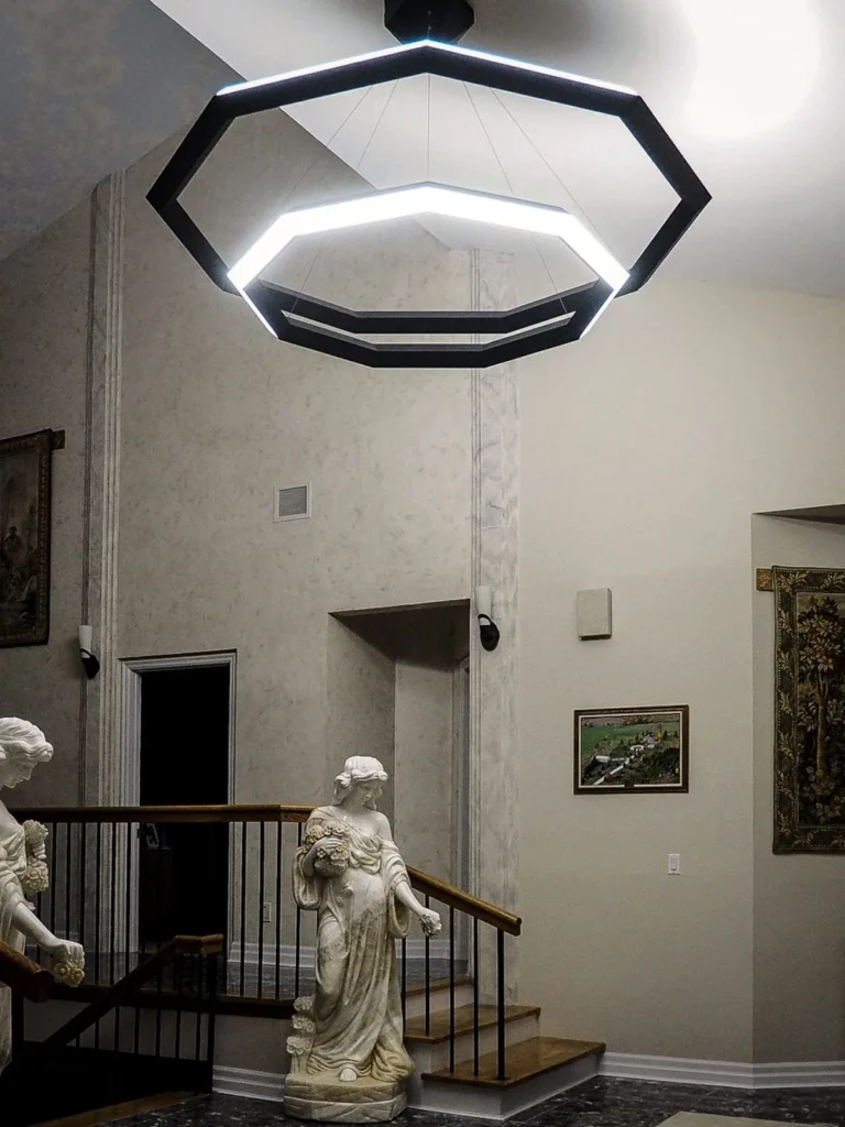 Luxennea Diamond sculptural chandelier with layered geometric tiers suspended by aircraft cables. Inspired by the Florentine Diamond. Designed and manufactured by Karice.