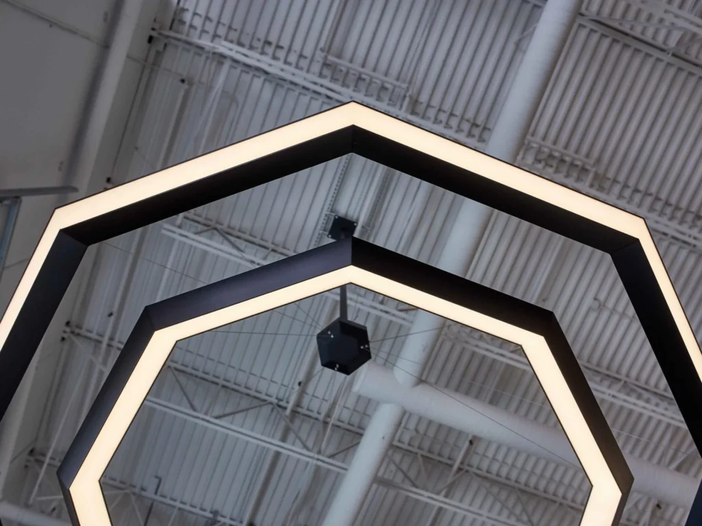 Luxennea Diamond sculptural chandelier with layered geometric tiers suspended by aircraft cables. Inspired by the Florentine Diamond. Designed and manufactured by Karice.