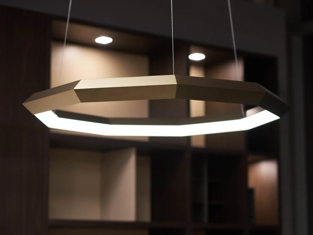Luxennea Diamond Series 2 LED chandelier with faceted enneagon design and ambient downlighting. Designed and manufactured by Karice.