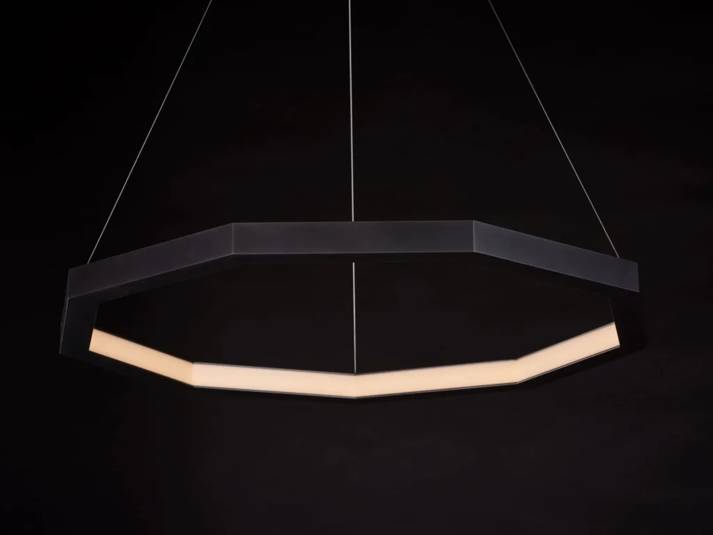 Luxennea Series 2 LED pendant with nine-sided geometric form, faceted aluminum construction, and inward diffused illumination. Designed and manufactured by Karice.